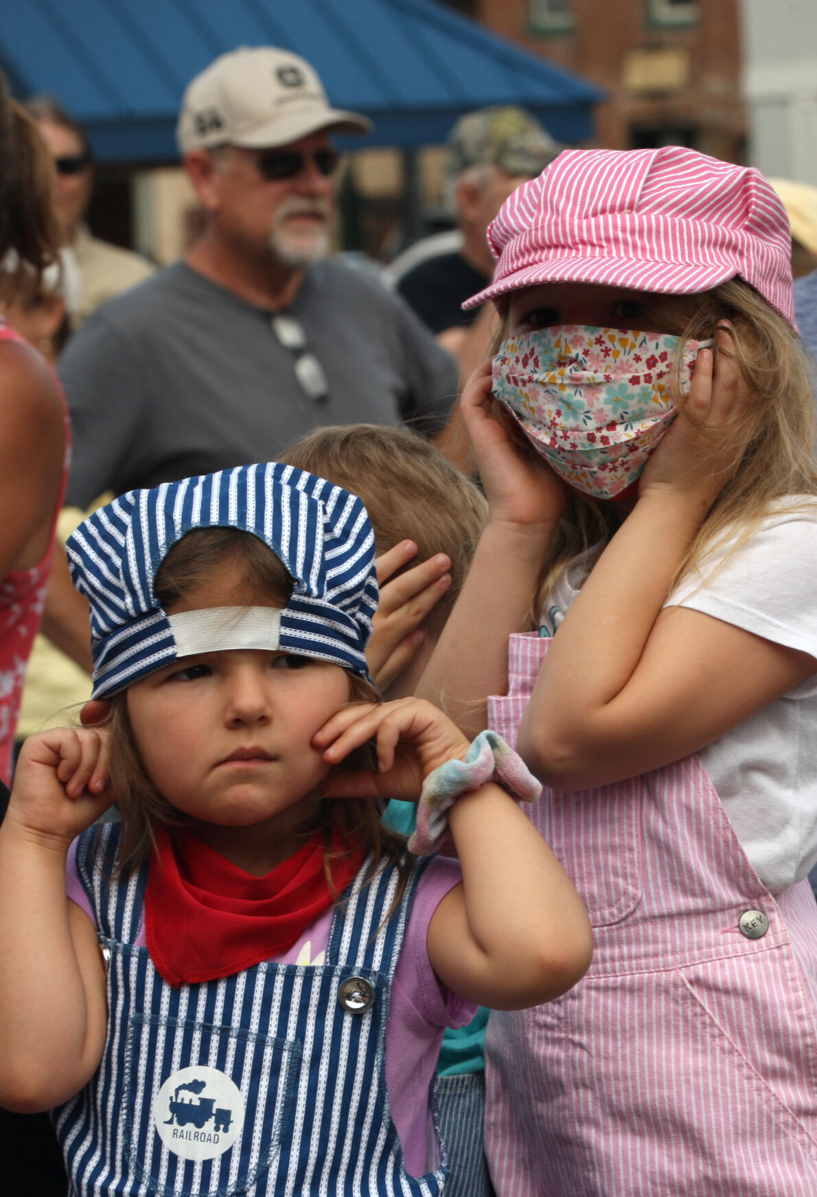 Eliza and Susanna Carrier cover their ears